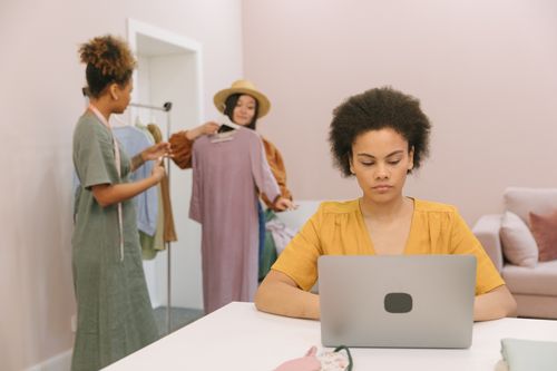 Free Diverse women working together with clothing in an office setting. Stock Photo