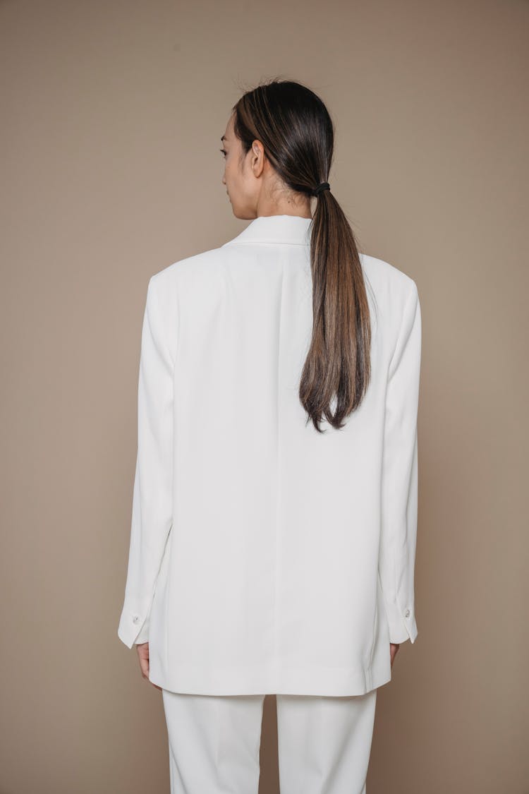 Back View Of Woman In Suit Posing In Studio