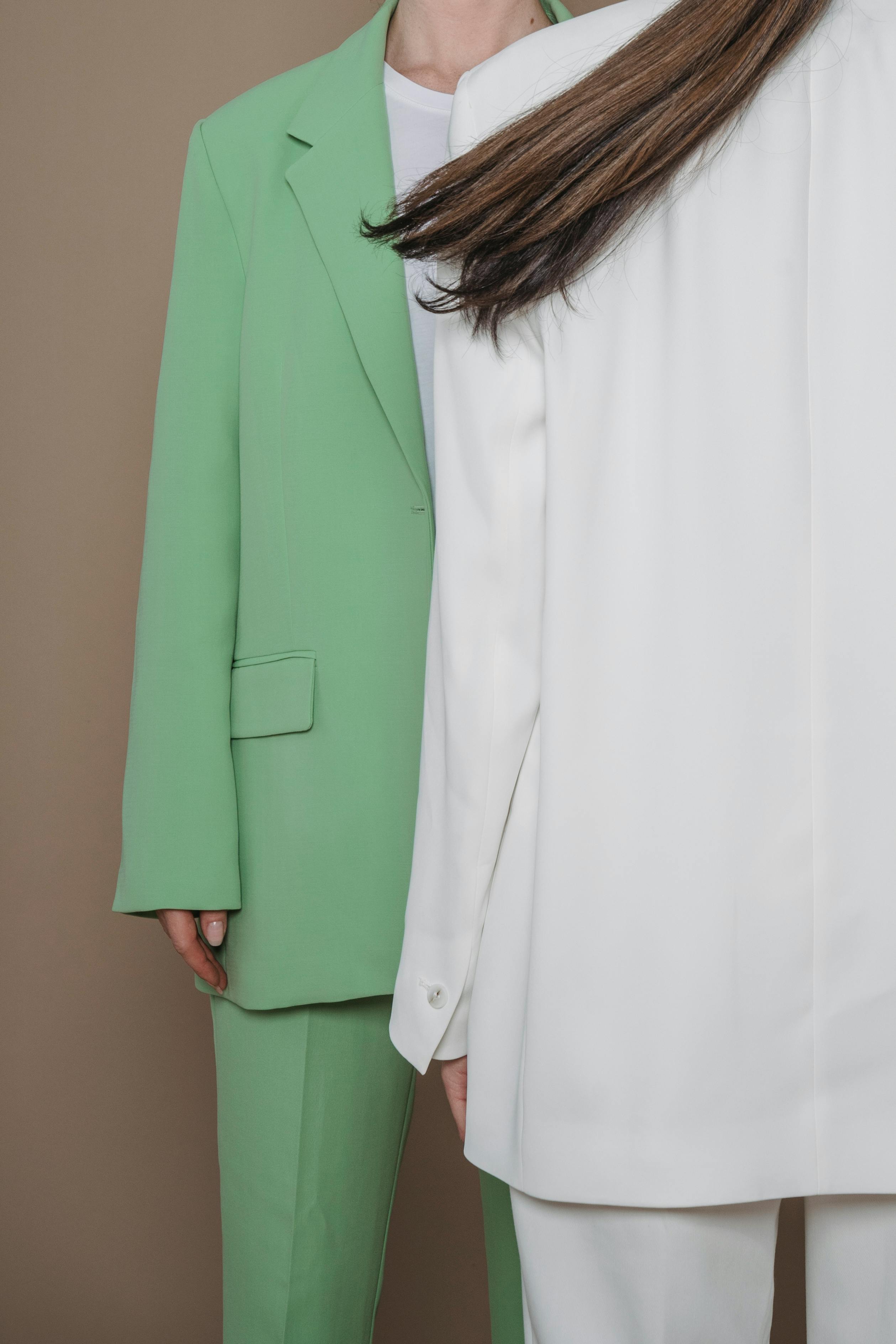 close up of women in suits posing in studio