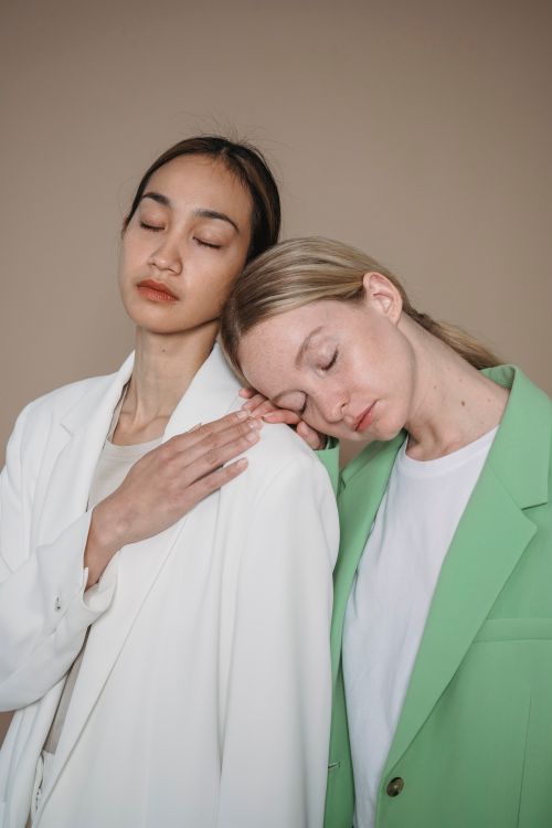 Free Two women sharing a peaceful moment together in a studio setting. Stock Photo