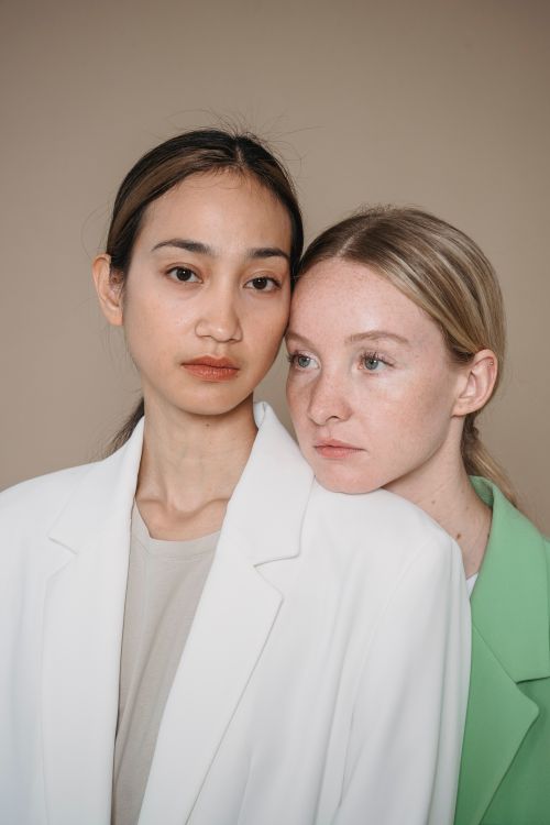 Free Stylish fashion portrait of two women in elegant blazers showcasing diversity and elegance. Stock Photo