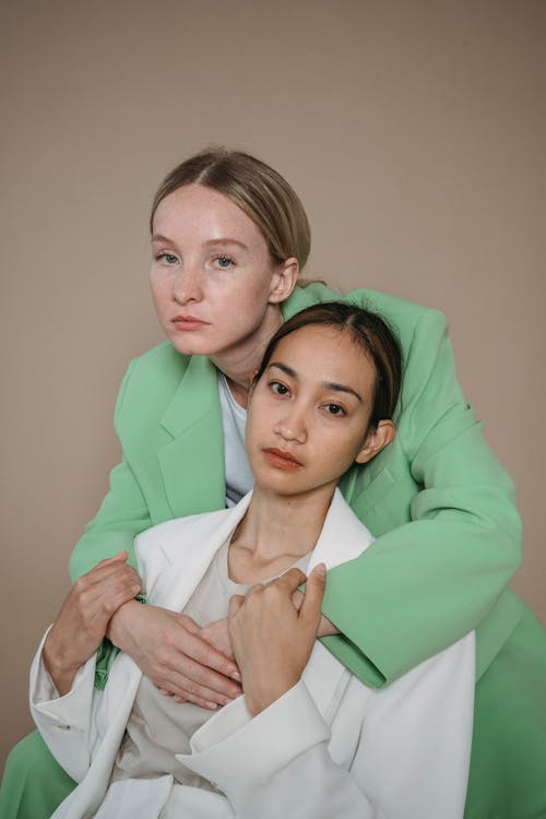Woman in Green Suit Hugging another Woman · Free Stock Photo