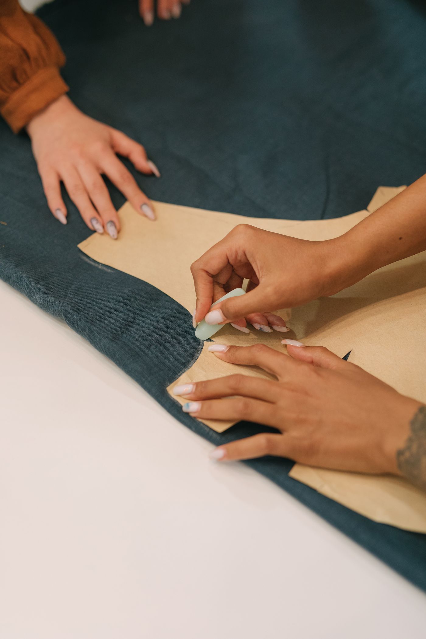 Hands of the Posh master tailor working on a garment
