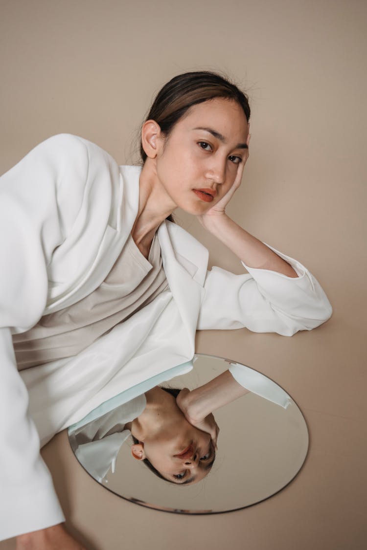 Woman Posing On The Floor With Her Hand On Cheek 