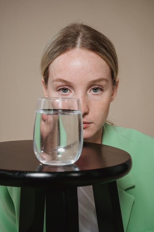 Free Clear Drinking Glass with Liquid Covering the Woman's Face  Stock Photo