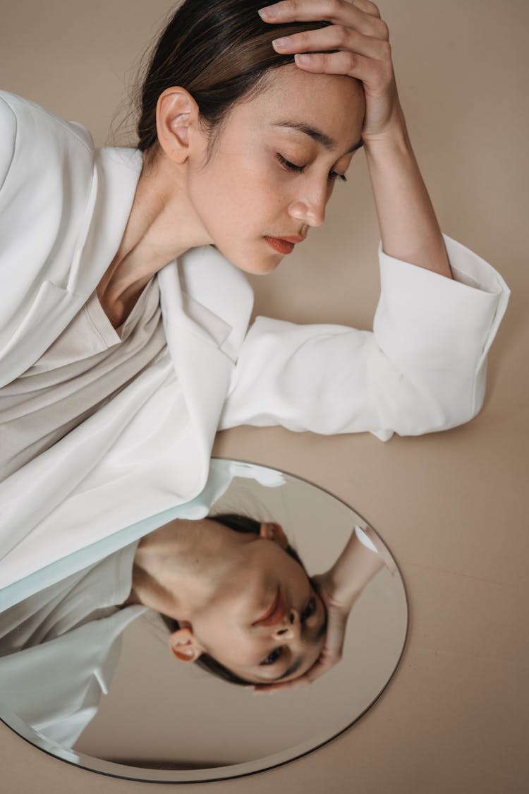 Woman In White Blazer Lying On The Floor