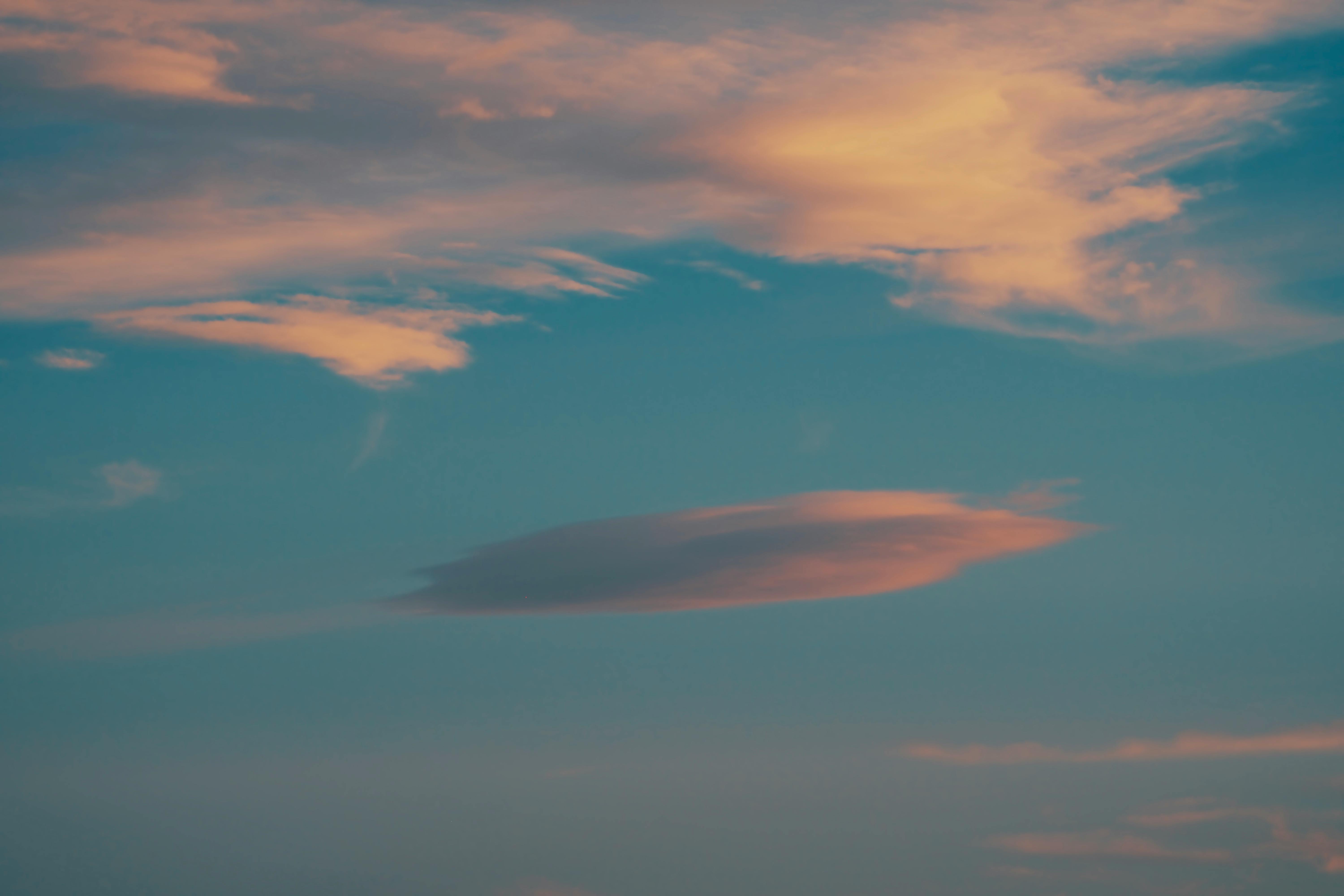 Tranquil evening sky with clouds gently glowing in the sunset over Joshua Tree.
