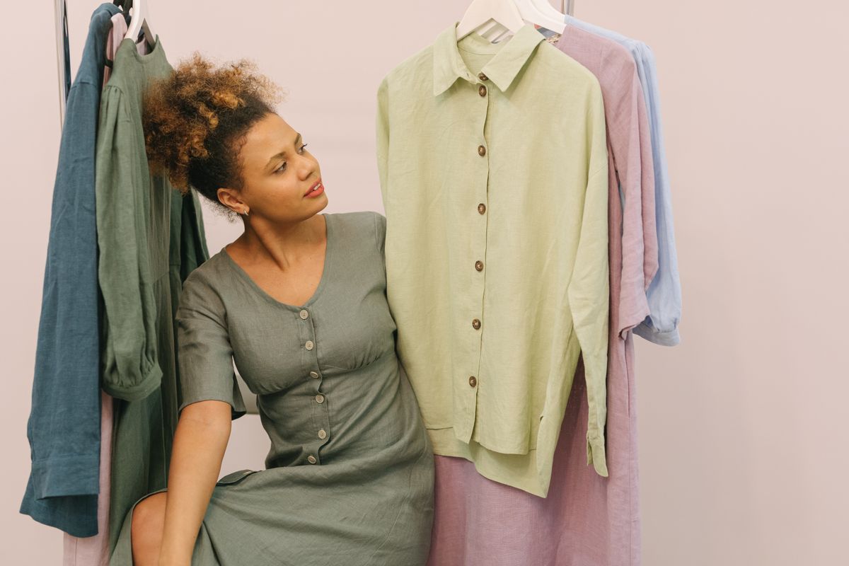 Woman browsing elegant linen clothing in a boutique