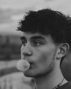 A Man Blowing a Bubble Gum