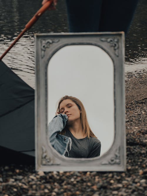 Reflection of Young Pretty Woman in Mirror Hanging at Tent