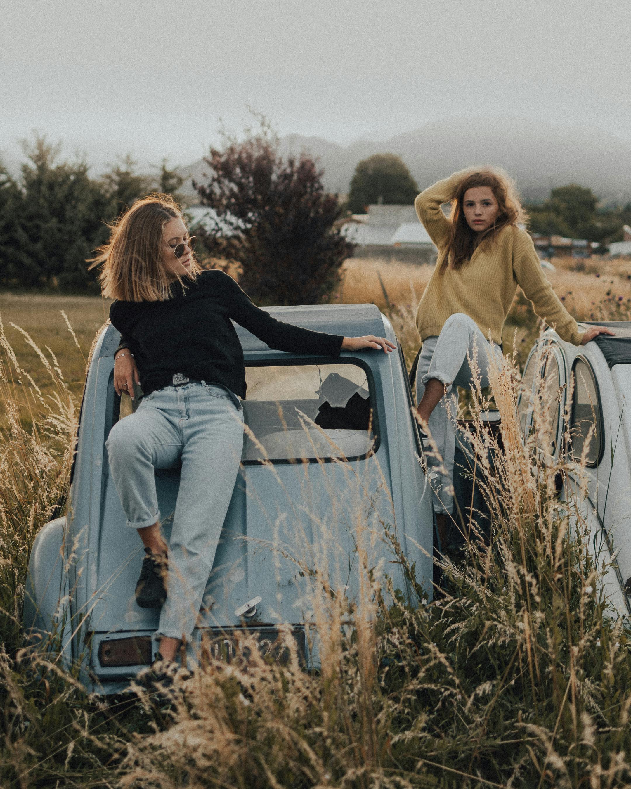 woman sitting on an abandoned car