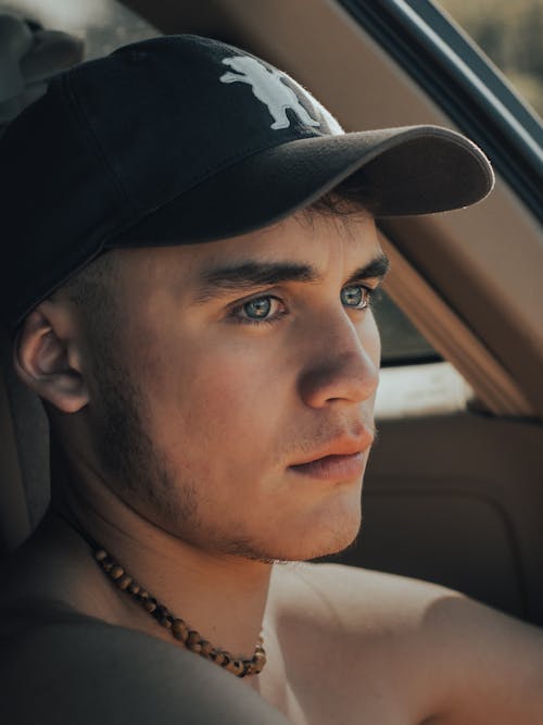 A Young Man Wearing a Black Cap