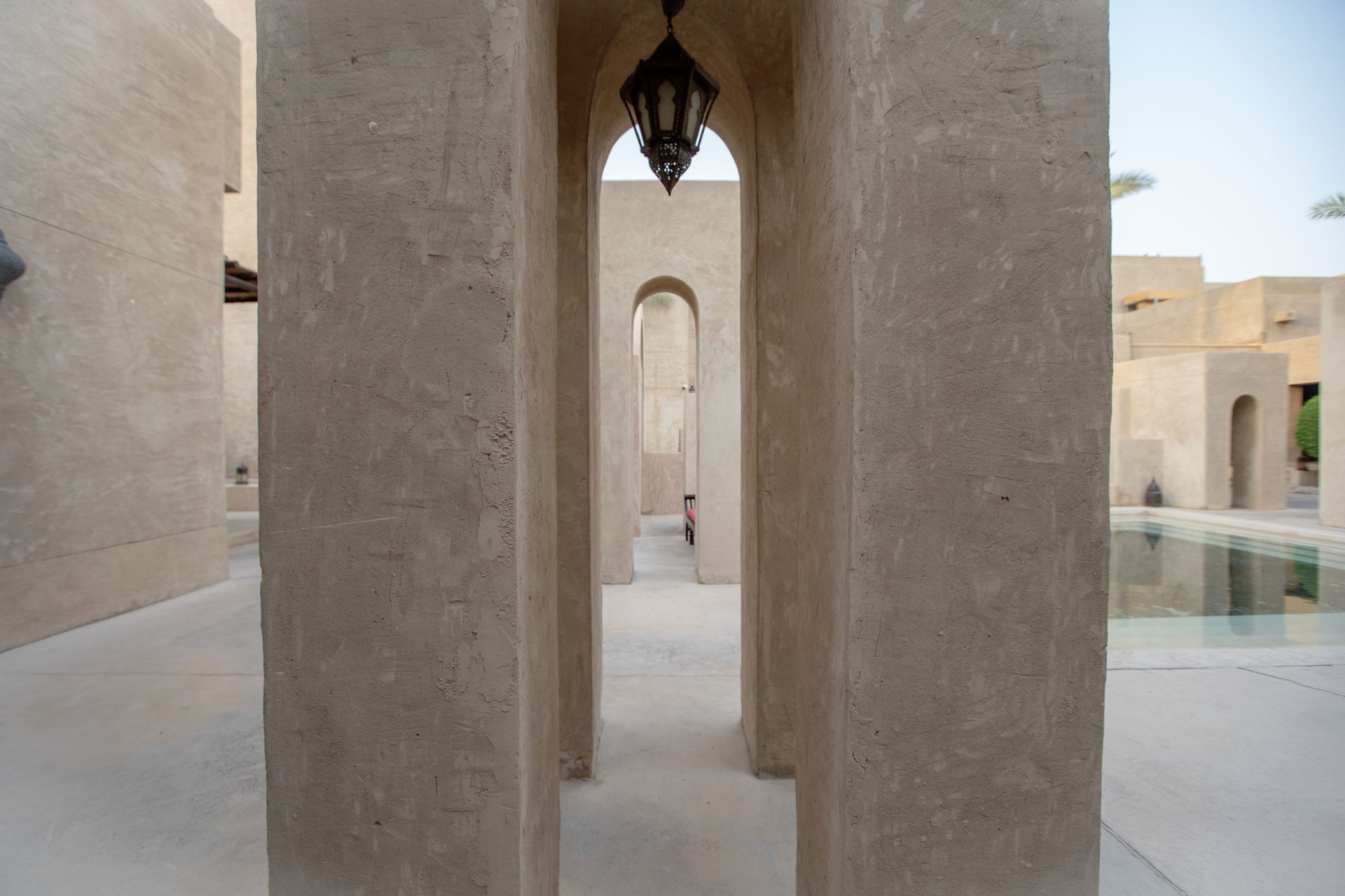 View of traditional stone pillars and lanterns in a Dubai courtyard.