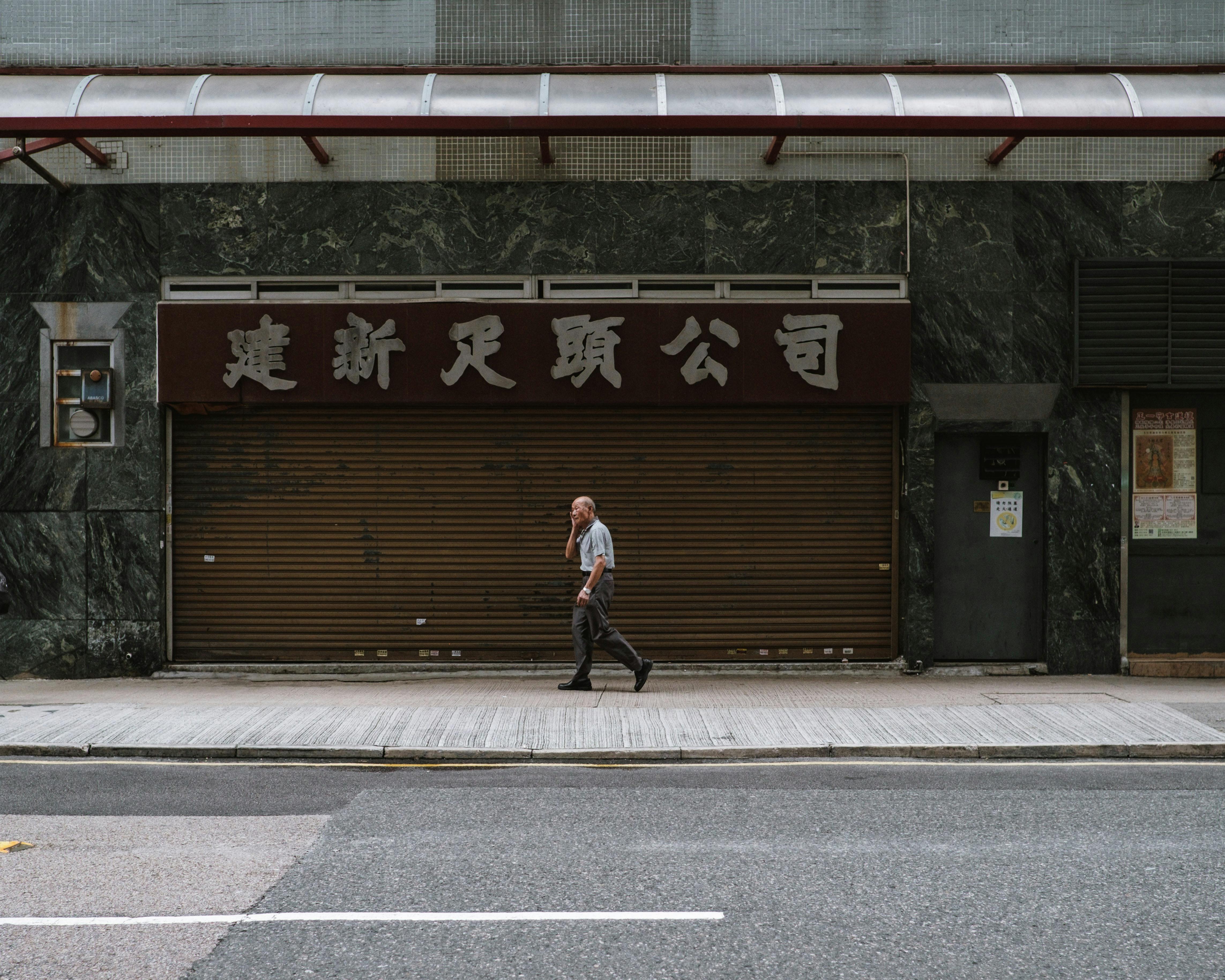 Elderly Man Walking outside a Building