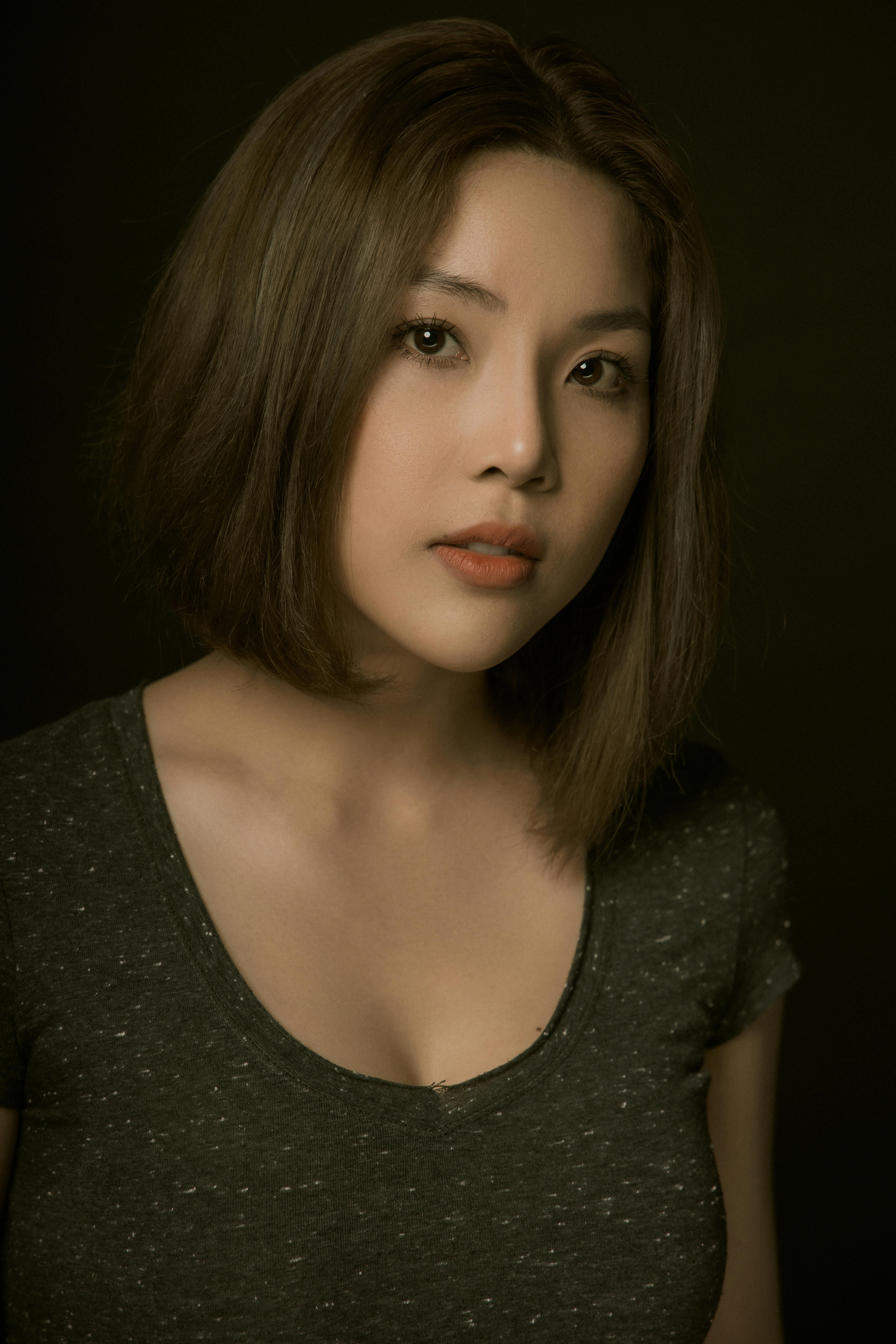 Close-up portrait of a young Asian woman with short hair, exuding elegance and beauty.