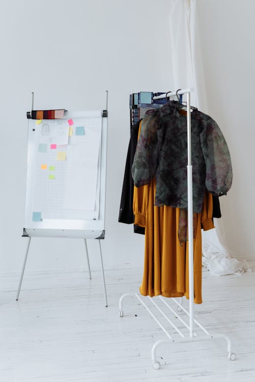 Free Whiteboard Near a Clothes Rack Stock Photo