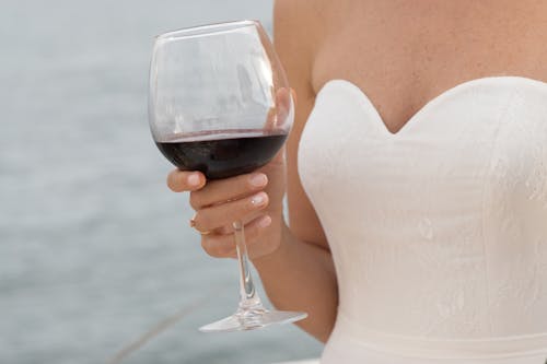 Woman in White Tube Dress Holding Wine Glass