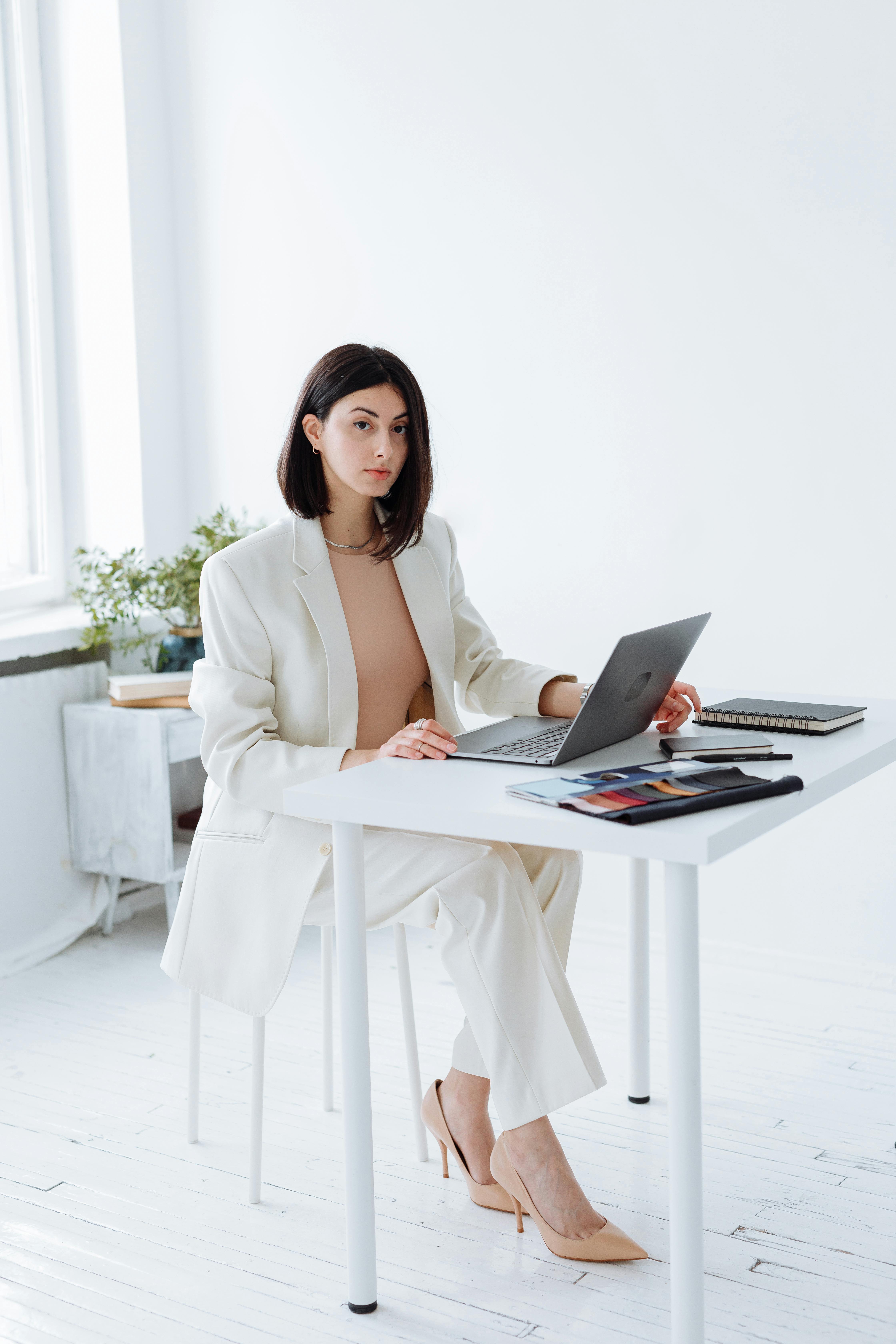 woman in white blazer at the office