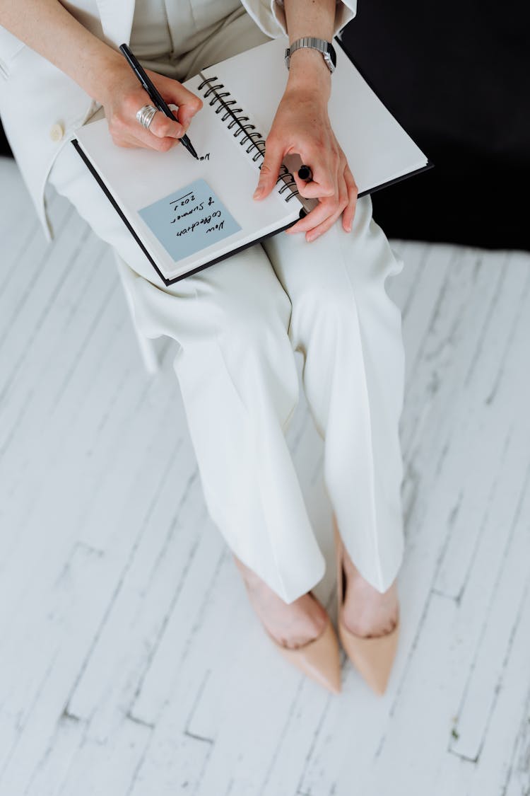 Woman Writing On A Notepad