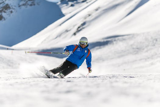 A skier carves down a sunlit snowy slope wearing protective gear, perfect for winter sports themes