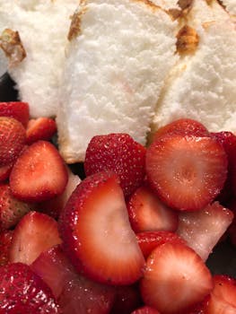Fresh and ripe strawberries with angel food cake, a sweet and delicious dessert combination.