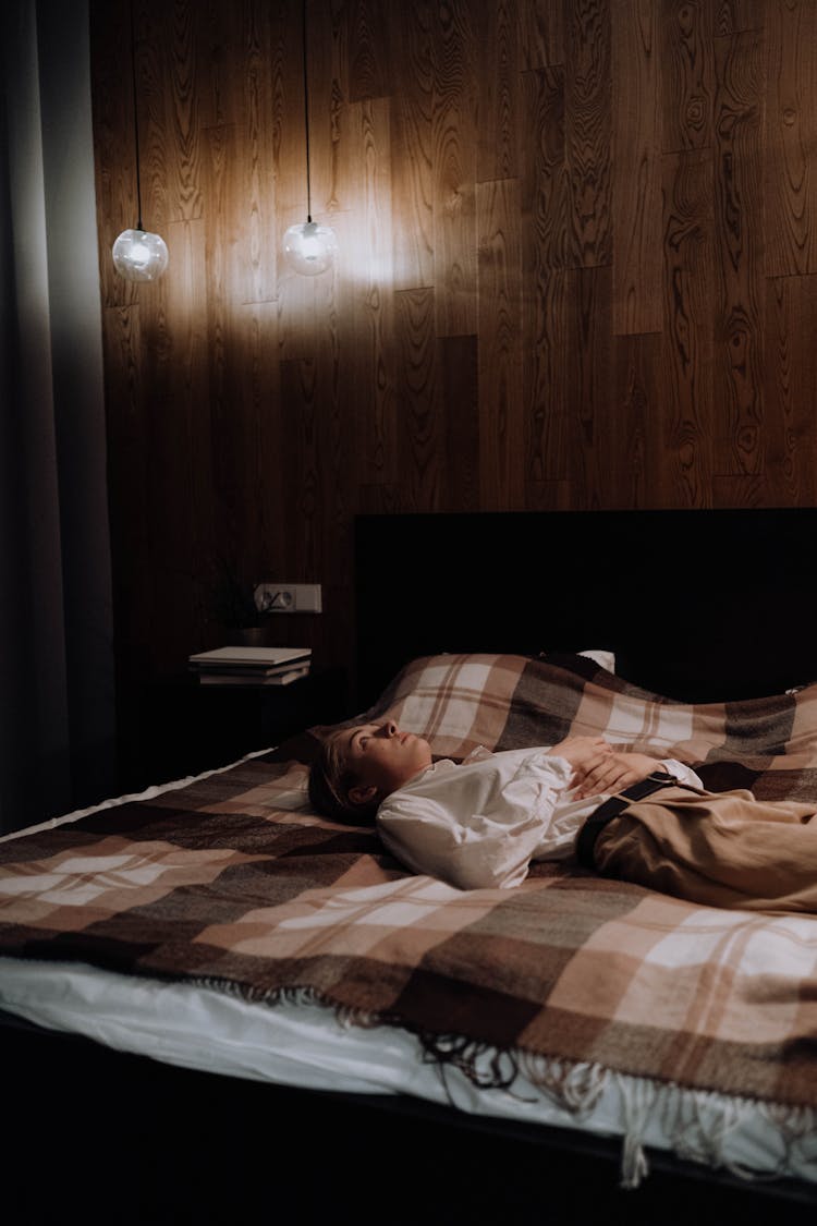 Depressed Woman Lying On The Bed