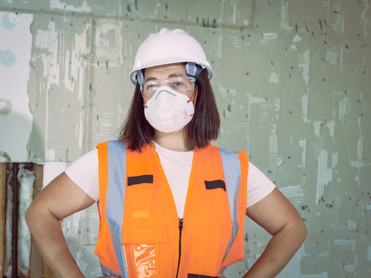 Female health and safety professional wearing protective equipment
