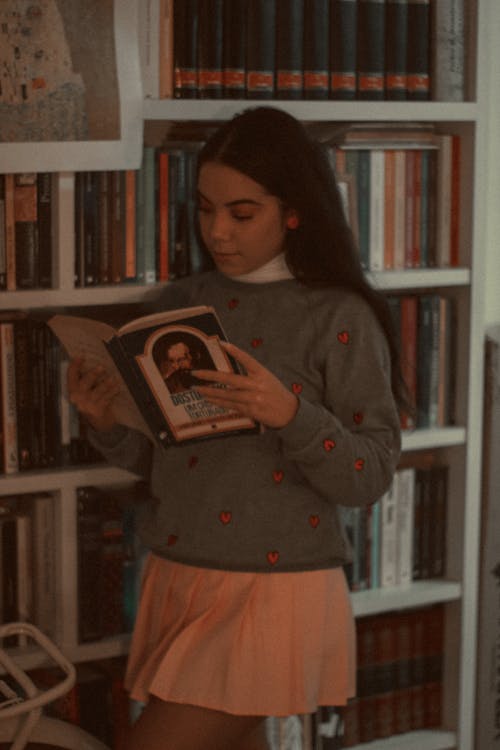 Free Woman in Gray Sweater Holding a Book Stock Photo