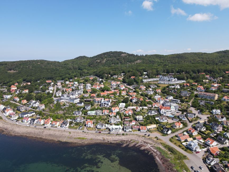 Aerial view of the picturesque coastal village of Höganäs in Skåne, Sweden, with charming houses and lush greenery.