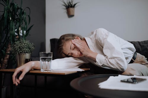 Free Exhausted Woman Falling Asleep On Table Stock Photo