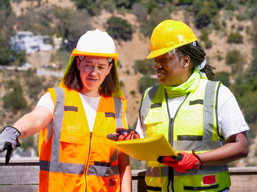 contractor on a job site wearing safety gear and reviewing plans - general liability insurance contractor on a job site wearing safety gear and reviewing plans - general liability insurance
