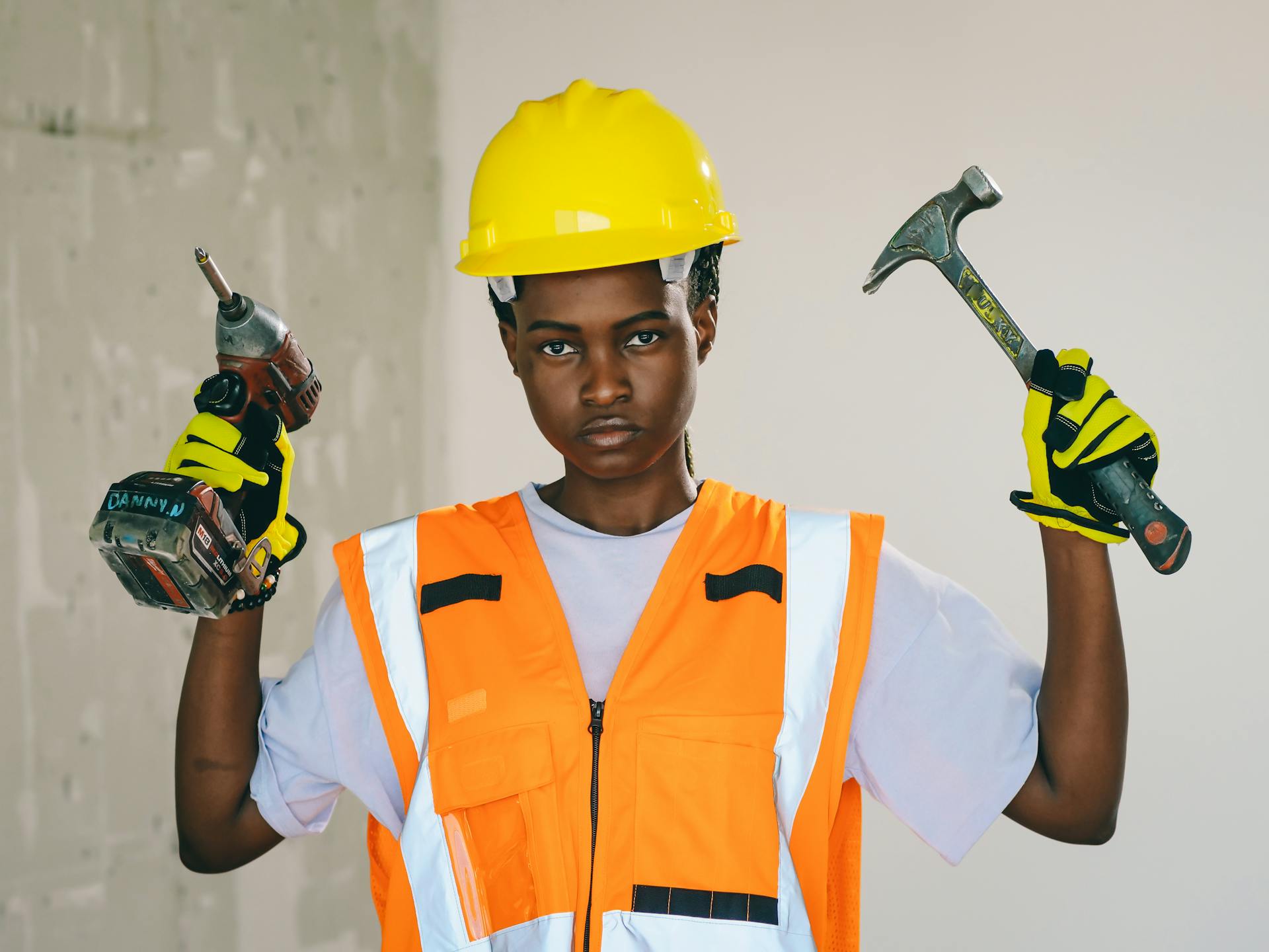 Handywoman Holding Hammer and Hand Drill 