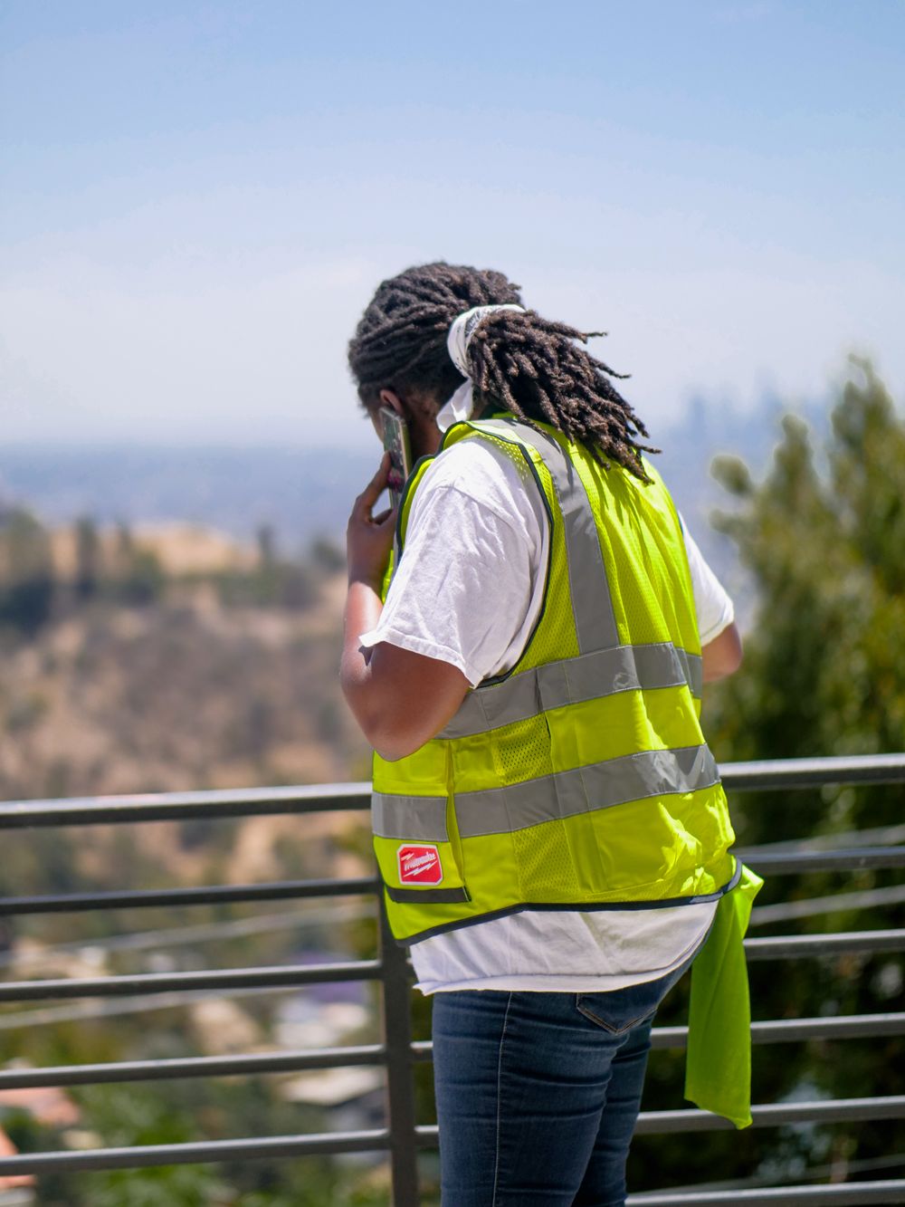 Worker taking a call on a job site