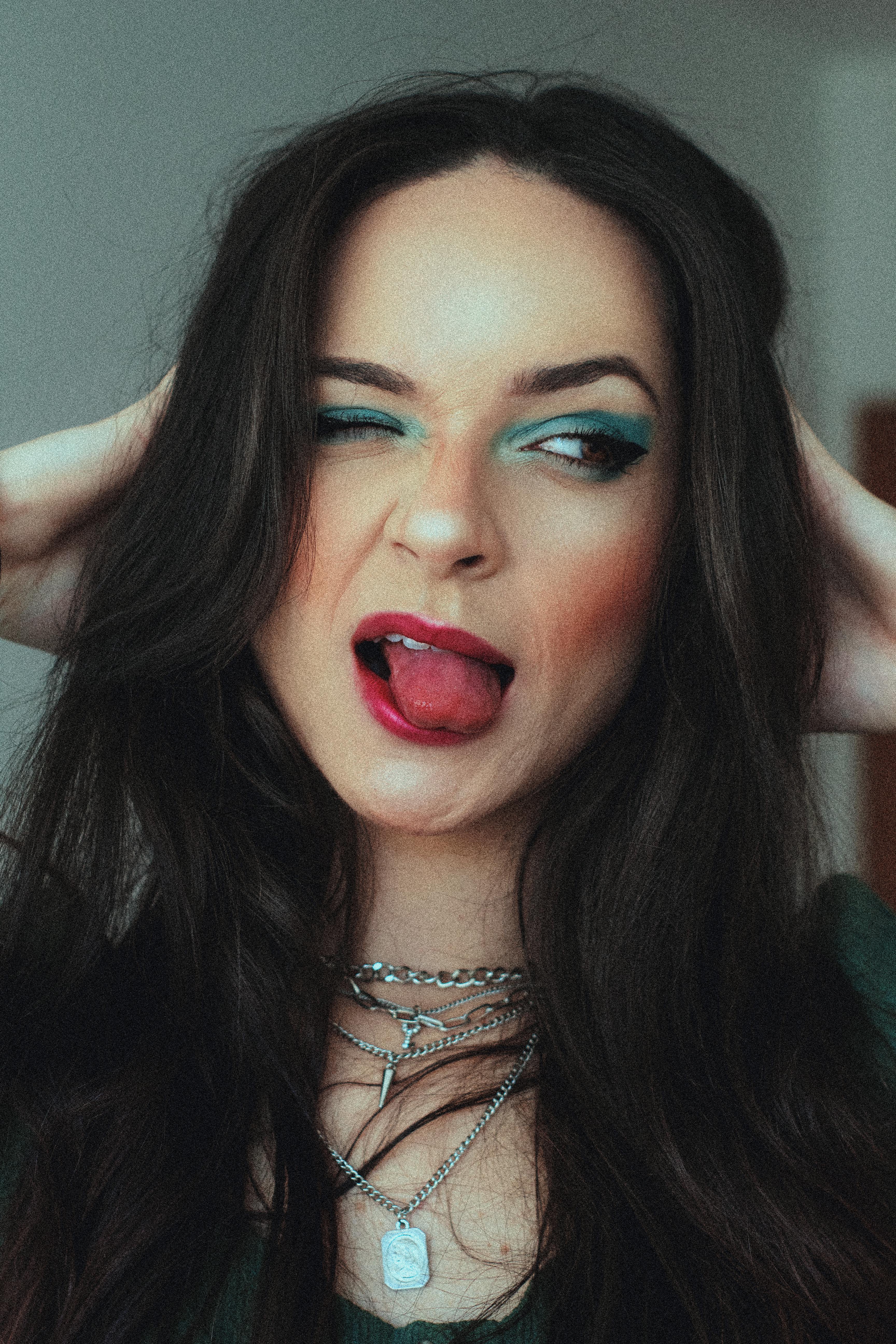 A fun portrait of a woman with bold makeup and jewelry, indoors in Santo André, Brazil.