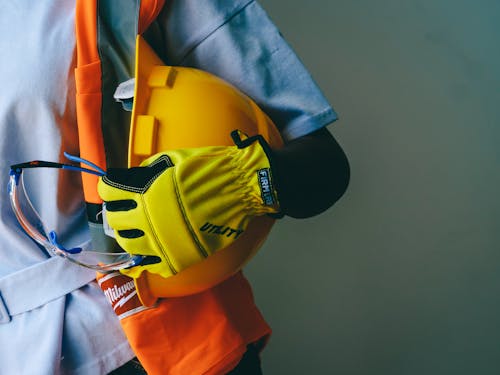 Free Close Up Photo of Person Holding Hardhat  Stock Photo
