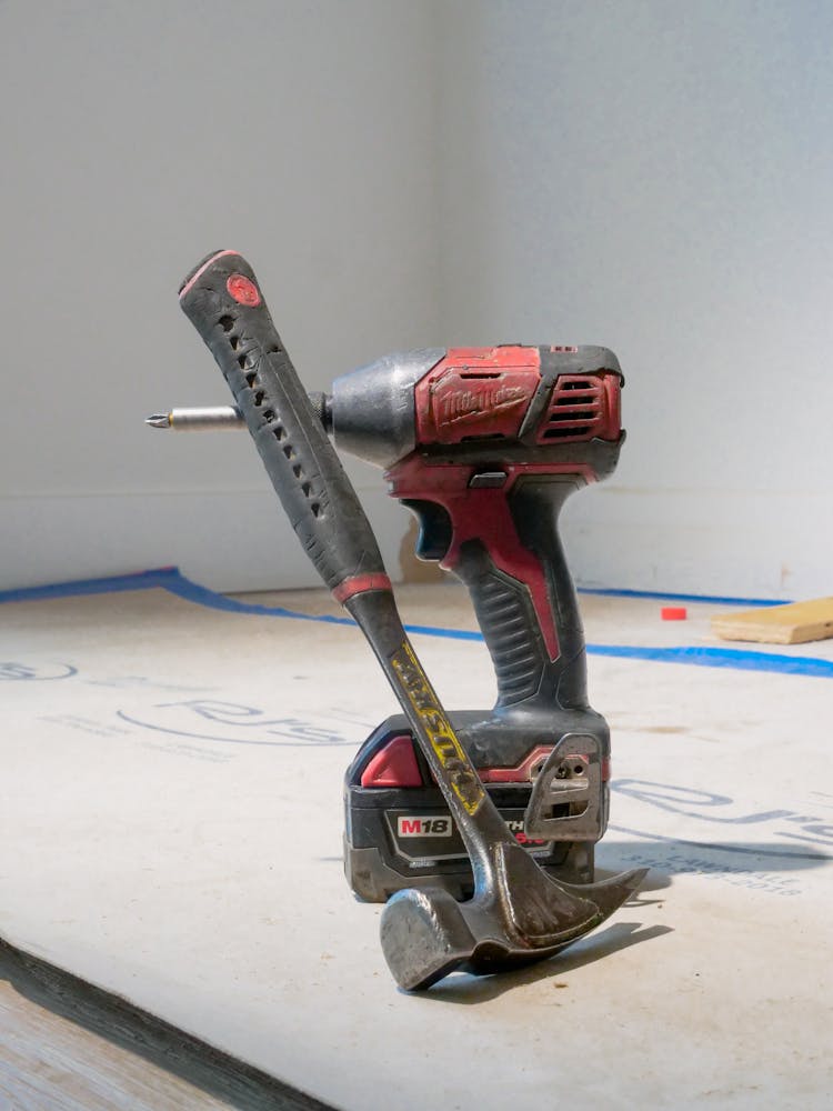 Hammer And Drill On Wooden Surface