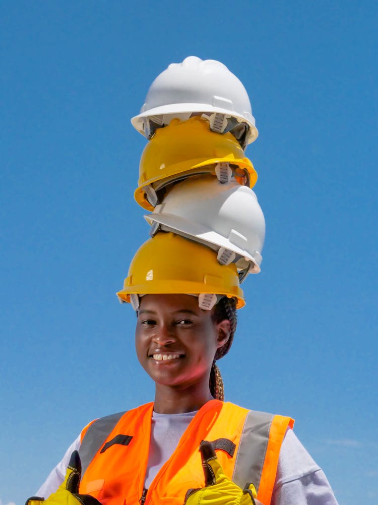 Hardhats Stacked On A Woman 