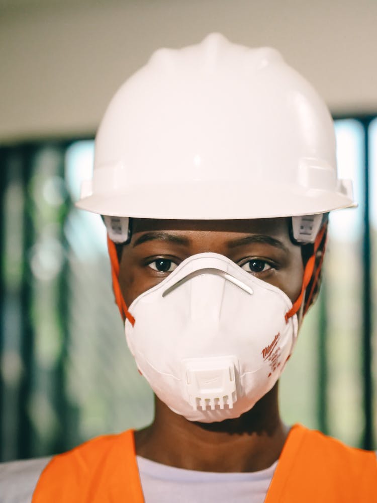 Person In WHite Hardhat And N95 Mask