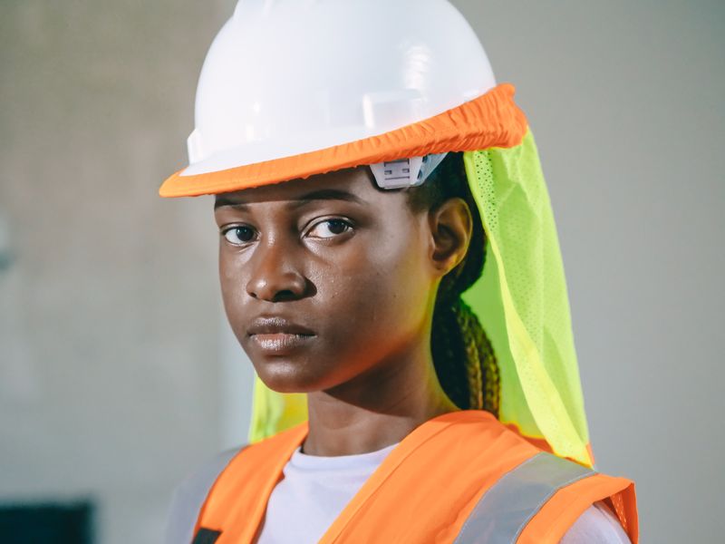 Female engineer in safety gear ready to assess an electrical system