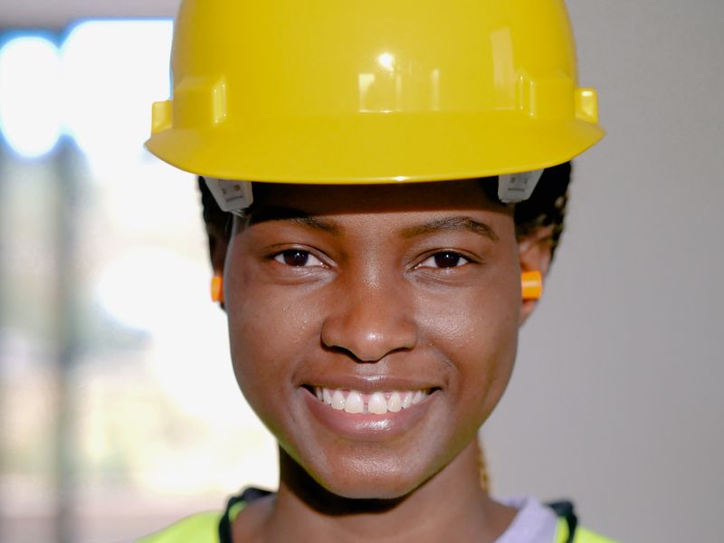 SteelCity engineer in a yellow hard hat checking structural details
