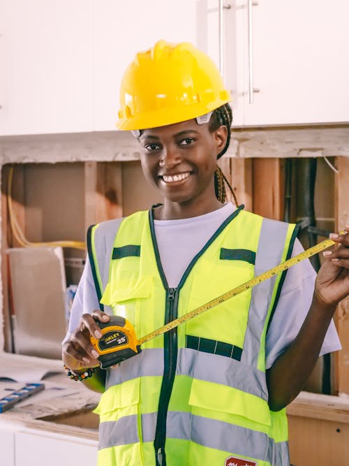 Free Woman Engineer Holding a Measuring Tape Stock Photo