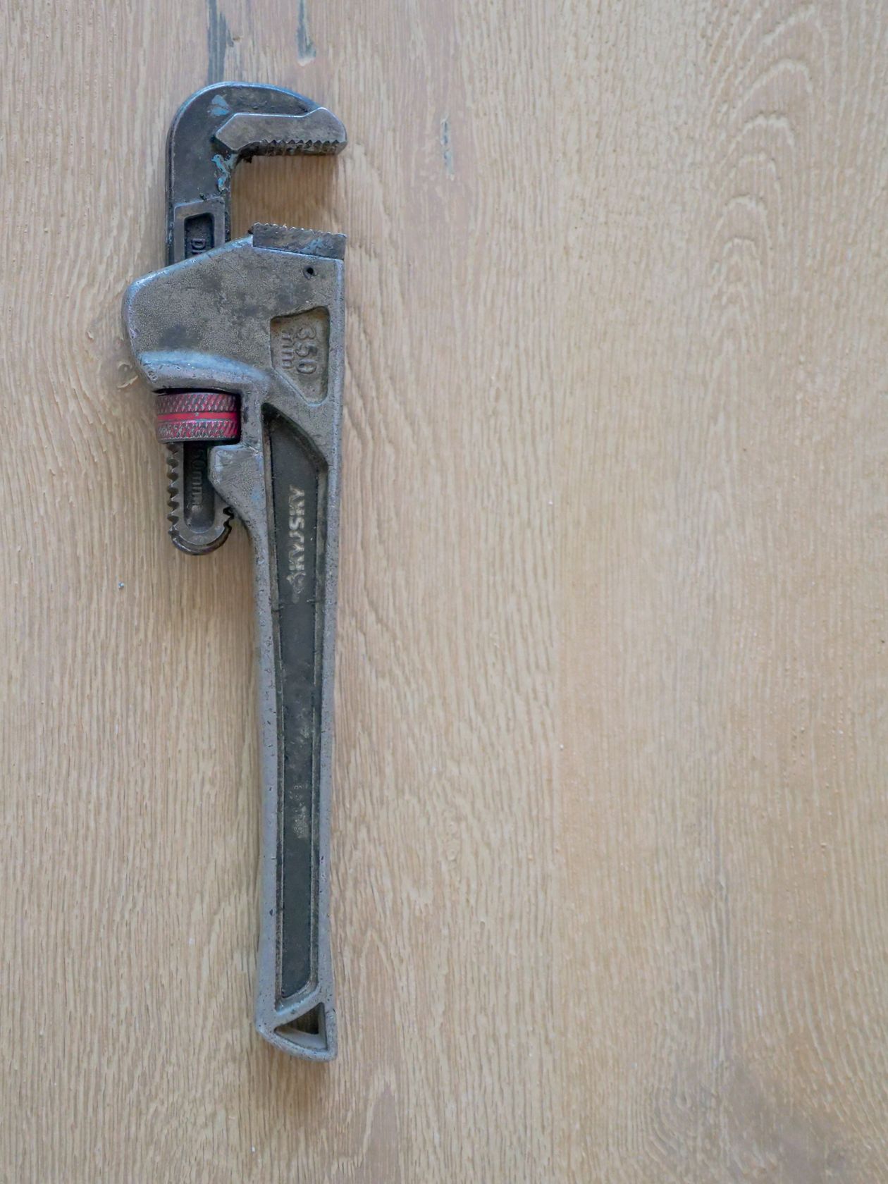 Plumber's wrench on a wooden surface