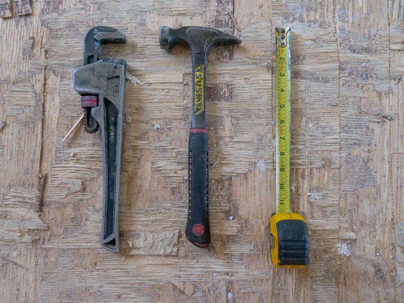 Handyman tools on a wooden work surface