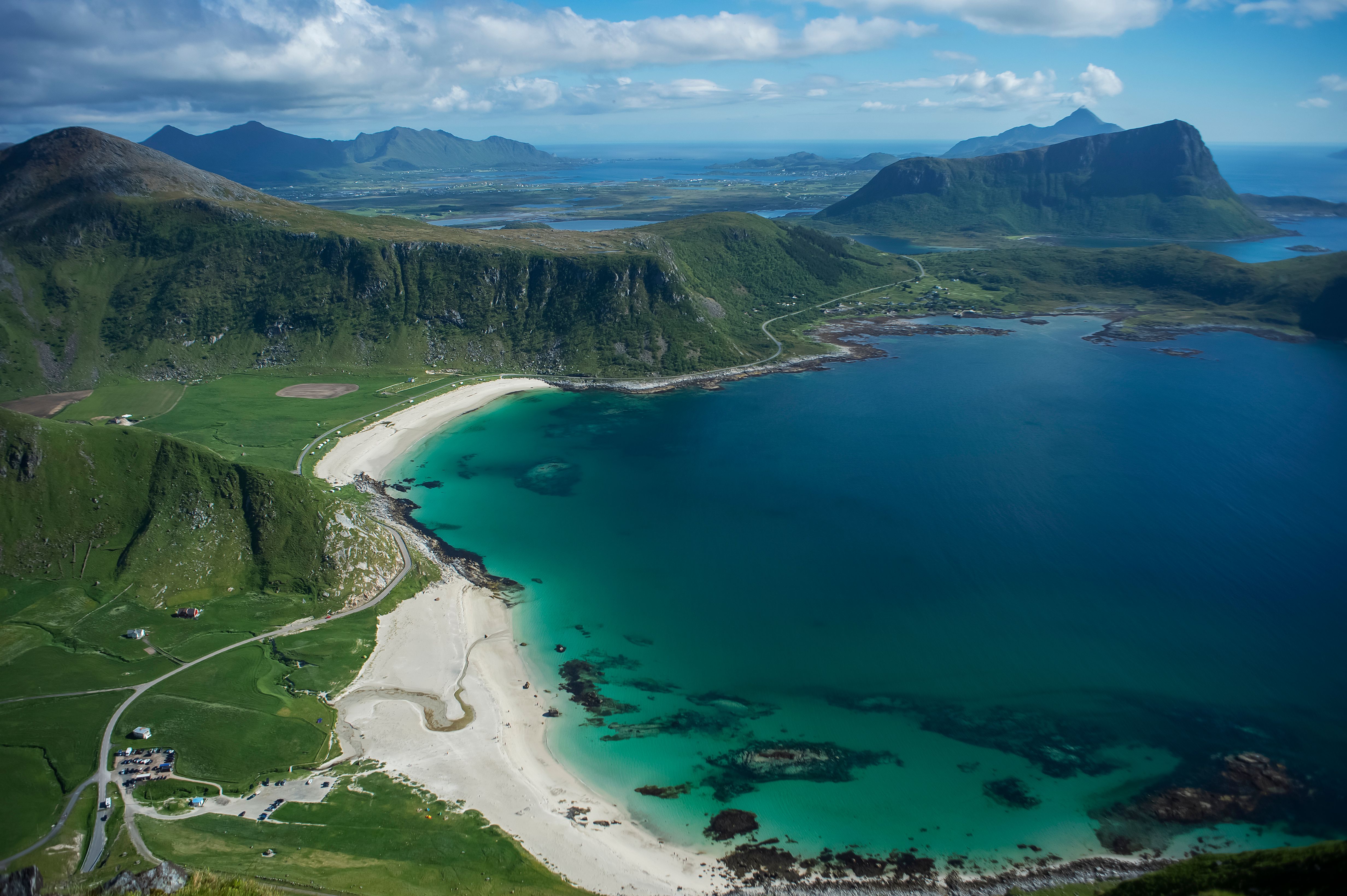 Aerial view of dramatic green mountains meeting a turquoise sea, Albania