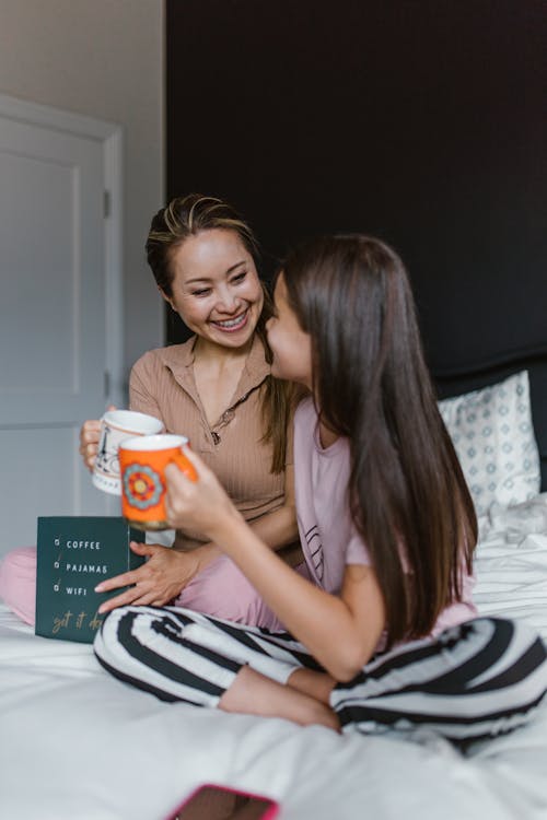 Mother and Daughter Sitting on the Bed