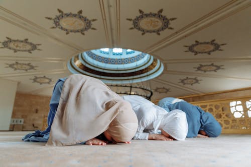 Woman in Traditional Clothing Bowing