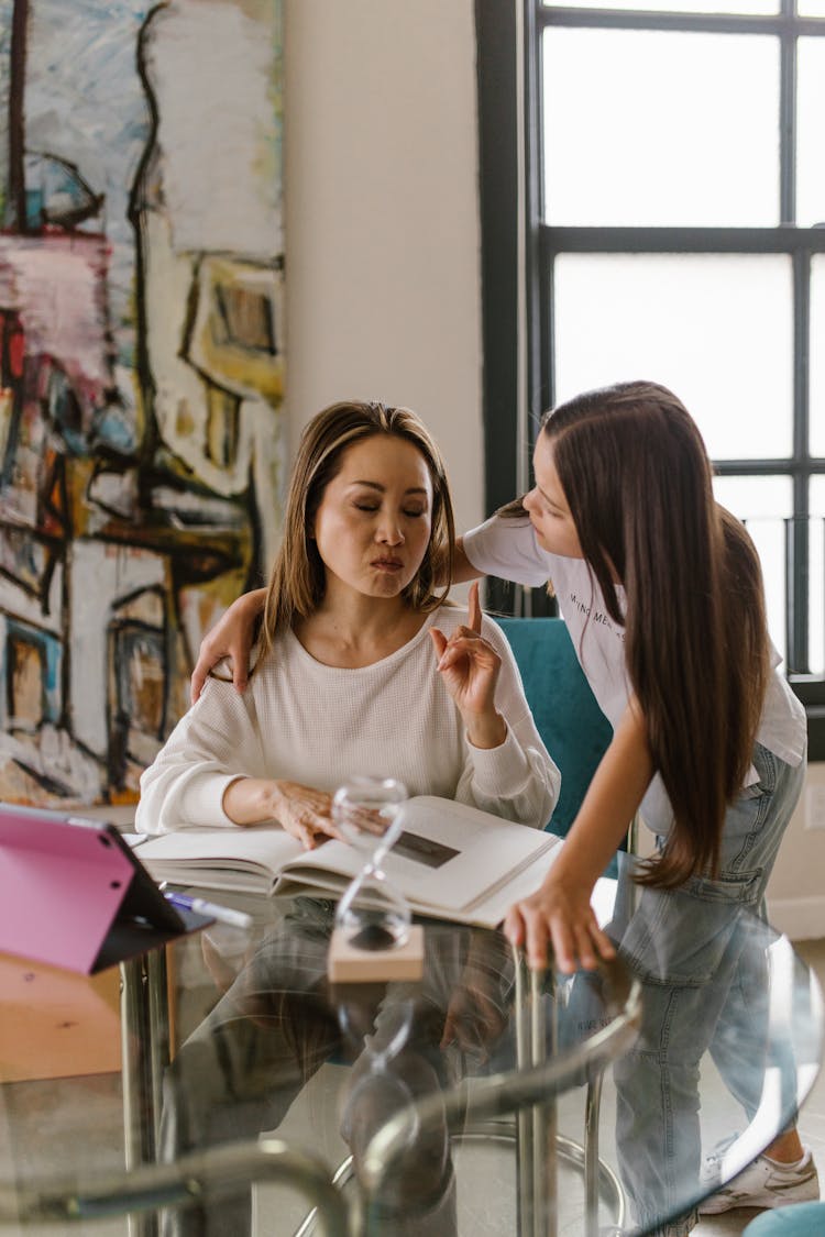 A Girl Distracting The Woman From Working