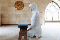 A Woman Kneeling on the Floor