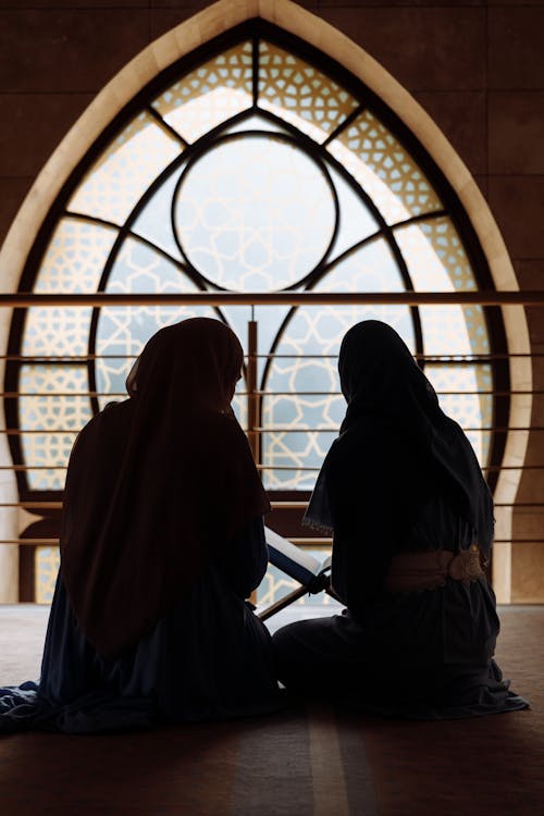 A Silhouette of Women Wearing Traditional Clothing