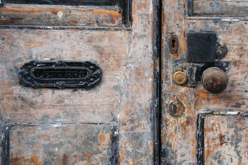 Free Black Mail Sliding on Ugly Wooden Door Stock Photo